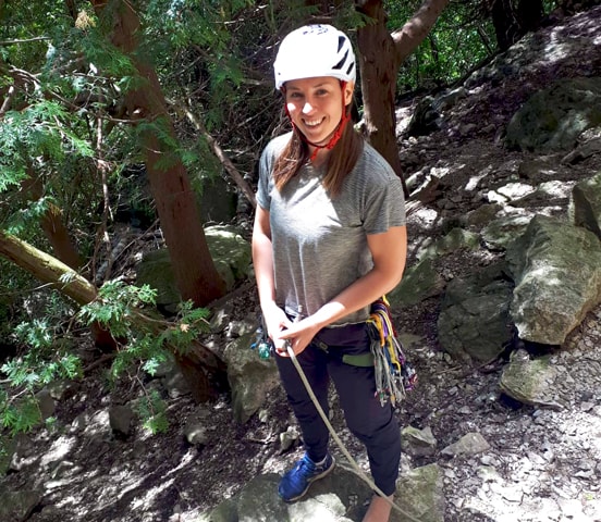 Kate wearing helmet ties into rope