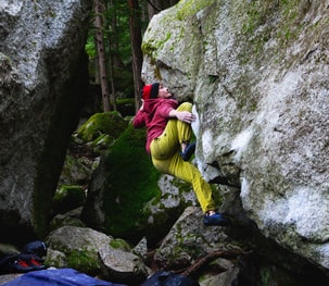 Climber in bright colours bouldering